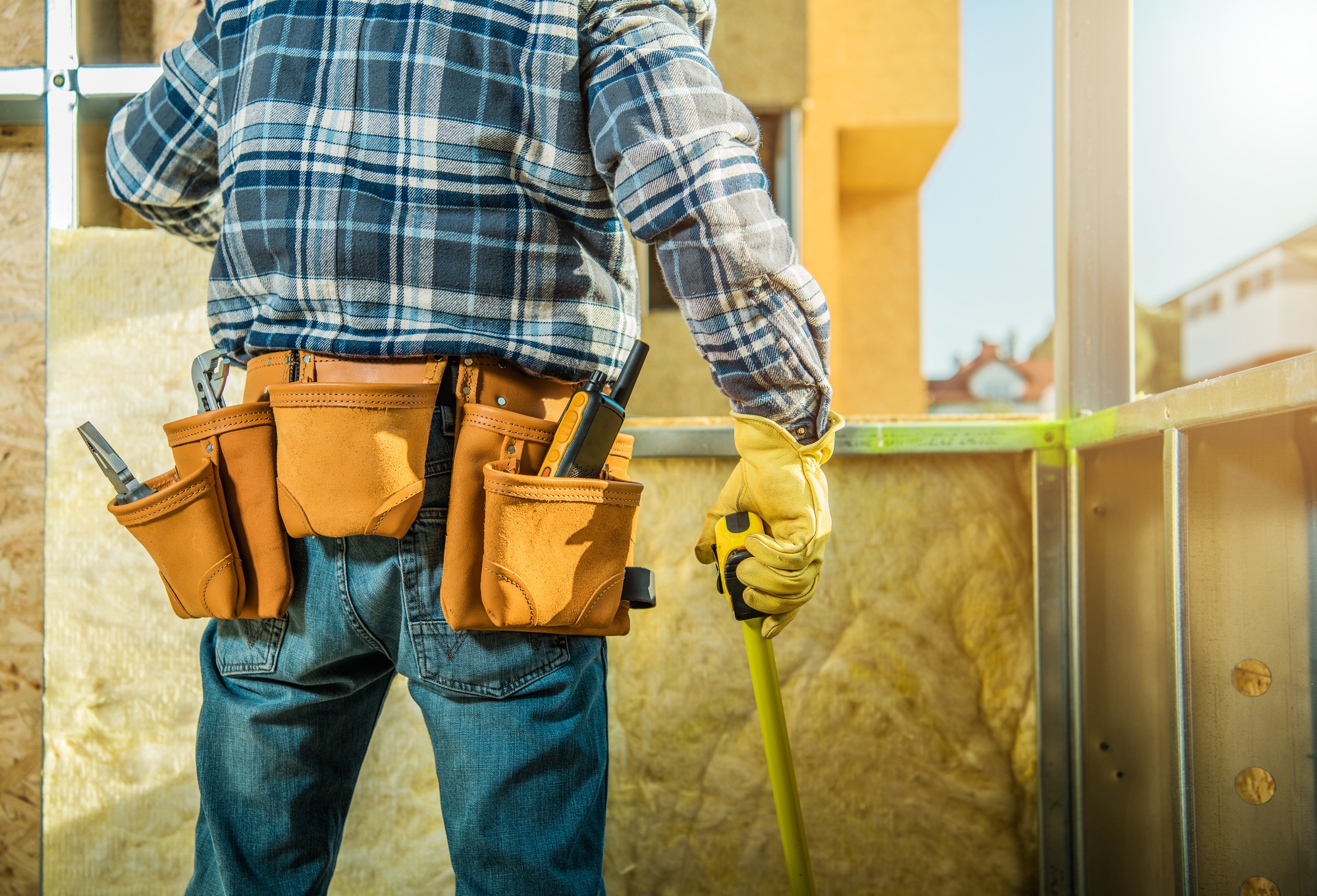Carpenter Measuring the Steel Frame of the Building